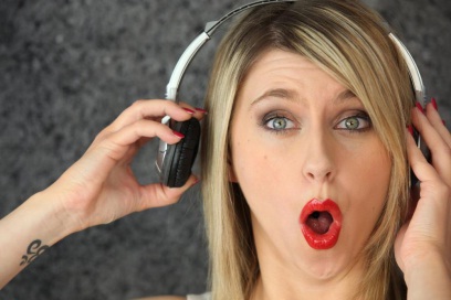 A woman listening to music with her headphones on.
