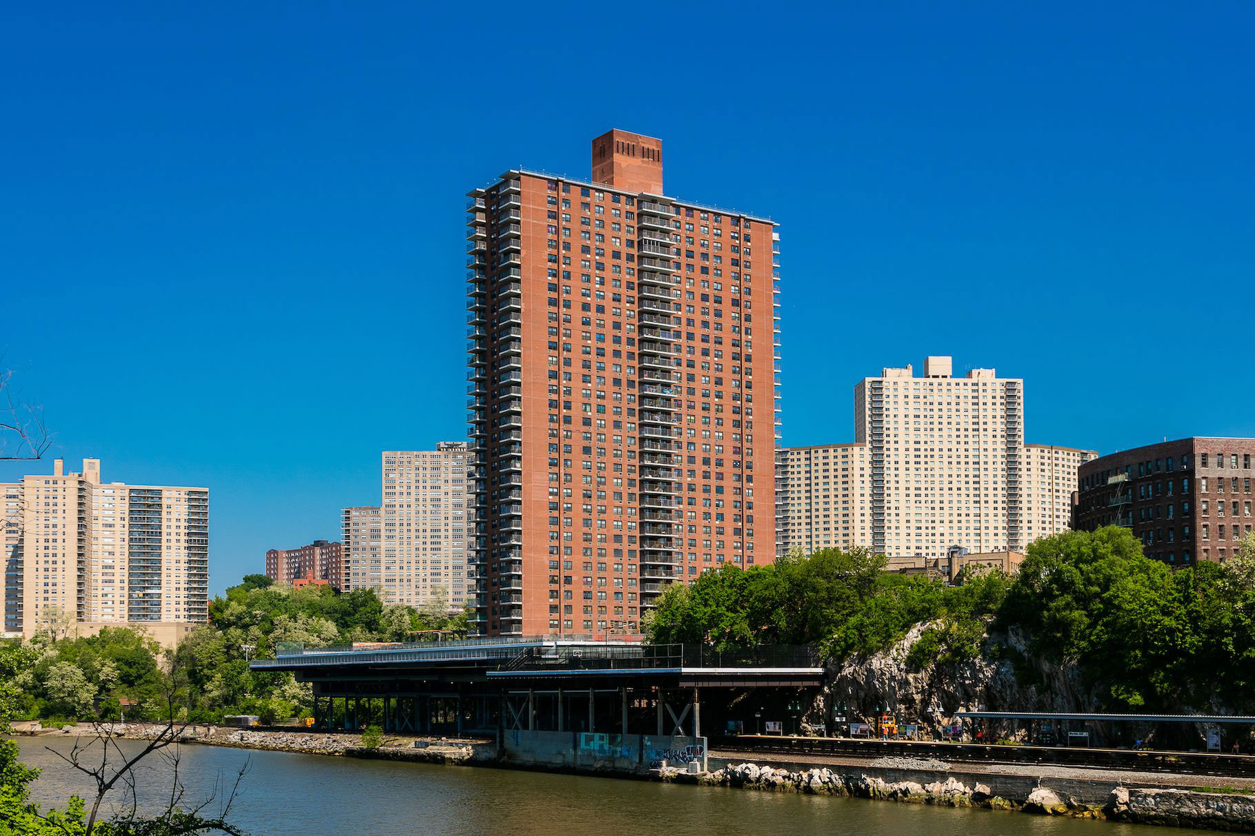 A photo of Promenade apartments building from across the river.